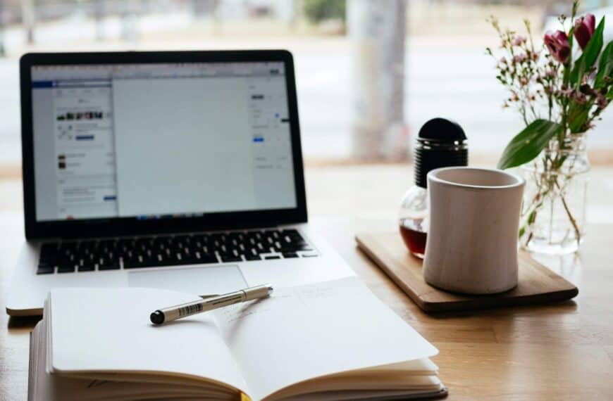 Open notebook in front of a laptop